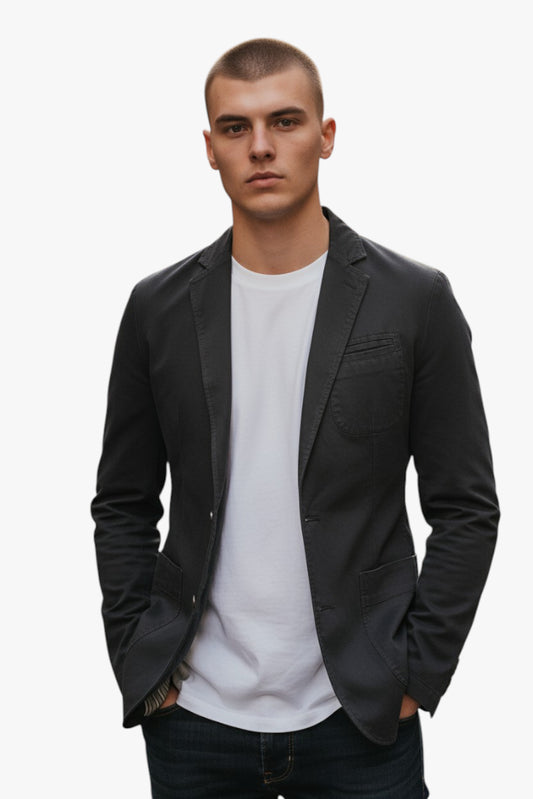 Man wearing a black blazer over a white shirt on a white background