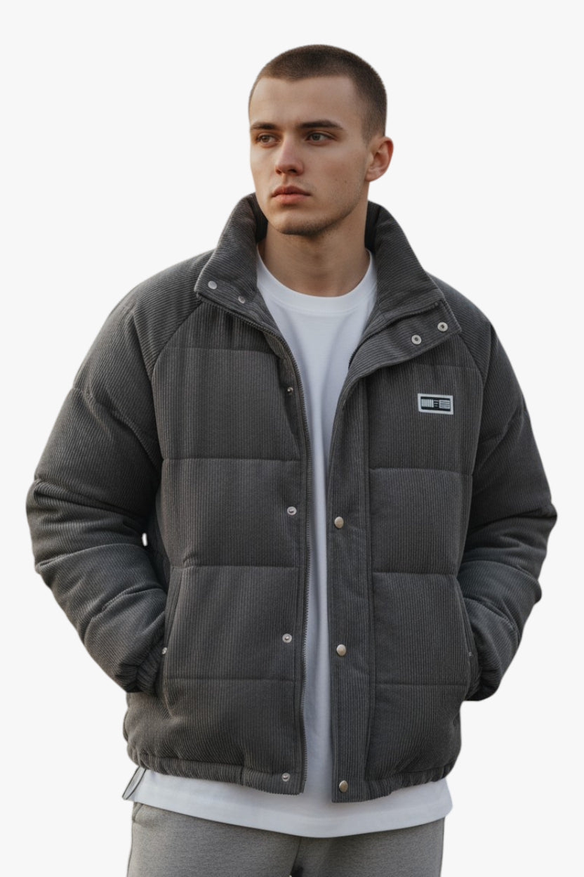 Man wearing a gray jacket with a brand logo on a white background