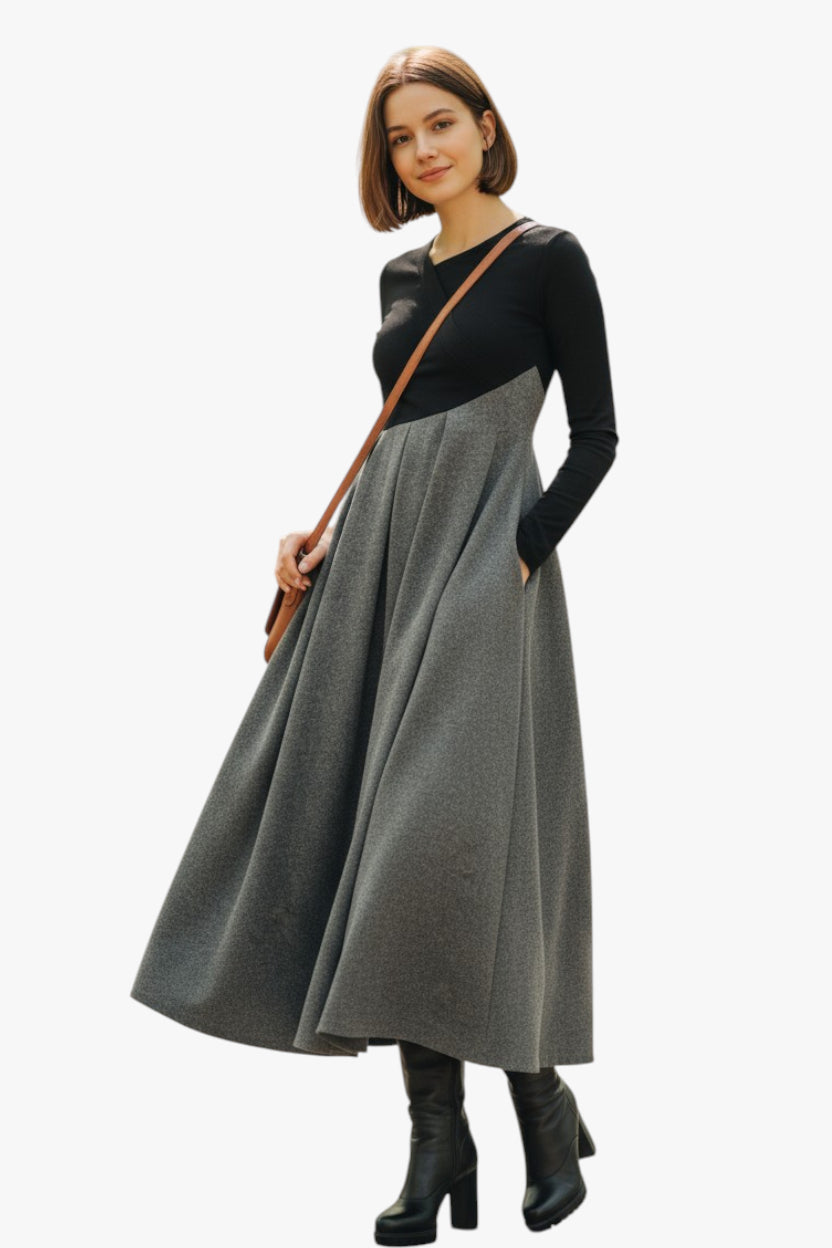 Woman wearing a black top and gray skirt with a brown strap over her shoulder on a white background