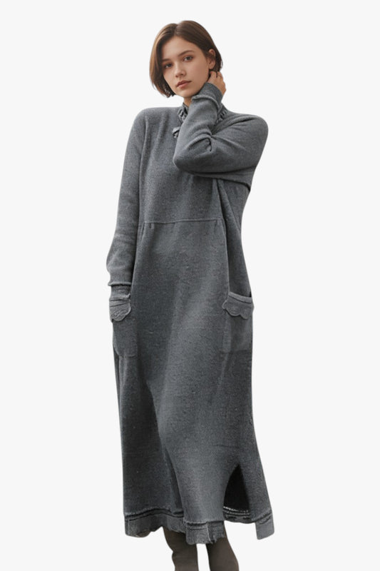 Woman wearing a long gray dress on a white background