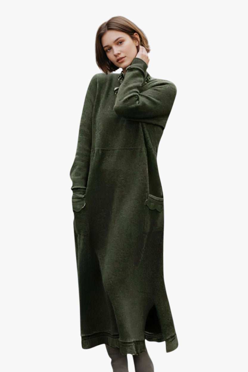 Woman wearing a long green dress against a white background