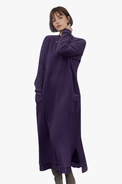 Woman wearing a long purple dress on a white background