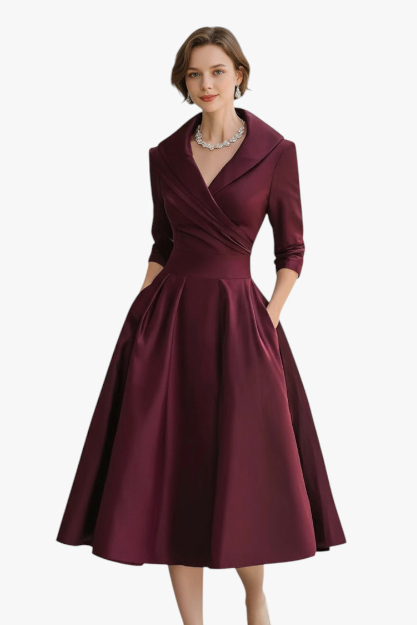 Woman wearing a burgundy dress with a white background