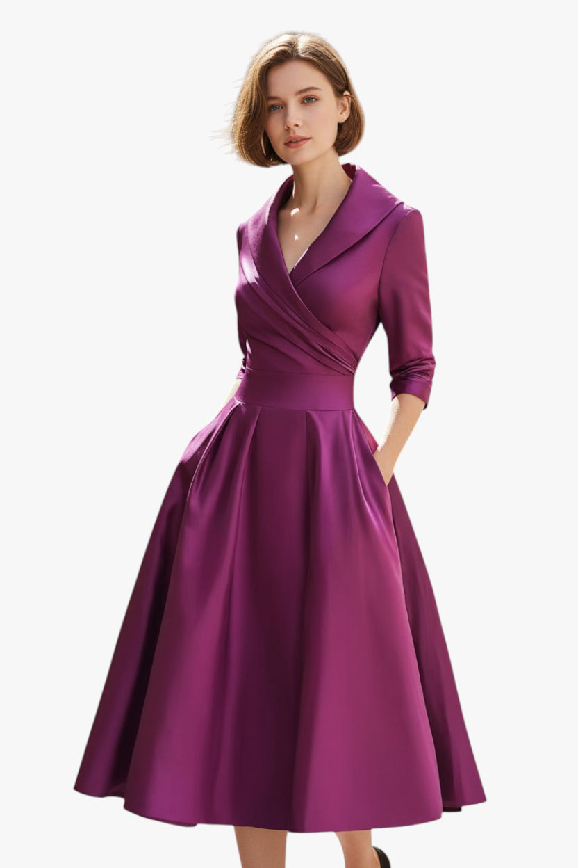 Woman wearing a purple dress with a white background